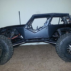 Mickey Thompson tires, RC4WD Hitman beadlocks, axial aluminum suspension links, flat black painted body