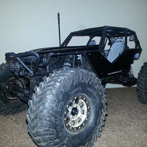 Mickey Thompson tires, RC4WD Hitman beadlocks, axial aluminum suspension links, flat black painted body