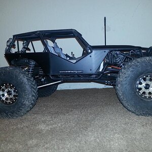 Mickey Thompson tires, RC4WD Hitman beadlocks, axial aluminum suspension links, flat black painted body