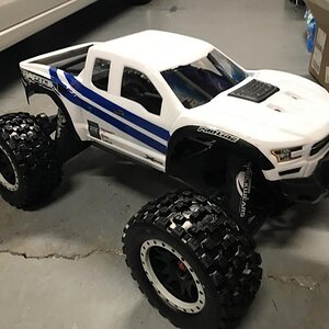 X-Maxx Pro-line Raptor body with Pro-line Badlands Tires MX43 with Impulse Pro-Loc Wheels