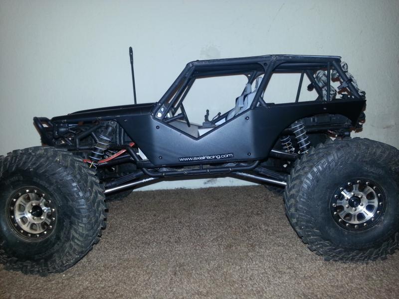 Mickey Thompson tires, RC4WD Hitman beadlocks, axial aluminum suspension links, flat black painted body