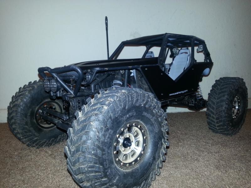 Mickey Thompson tires, RC4WD Hitman beadlocks, axial aluminum suspension links, flat black painted body