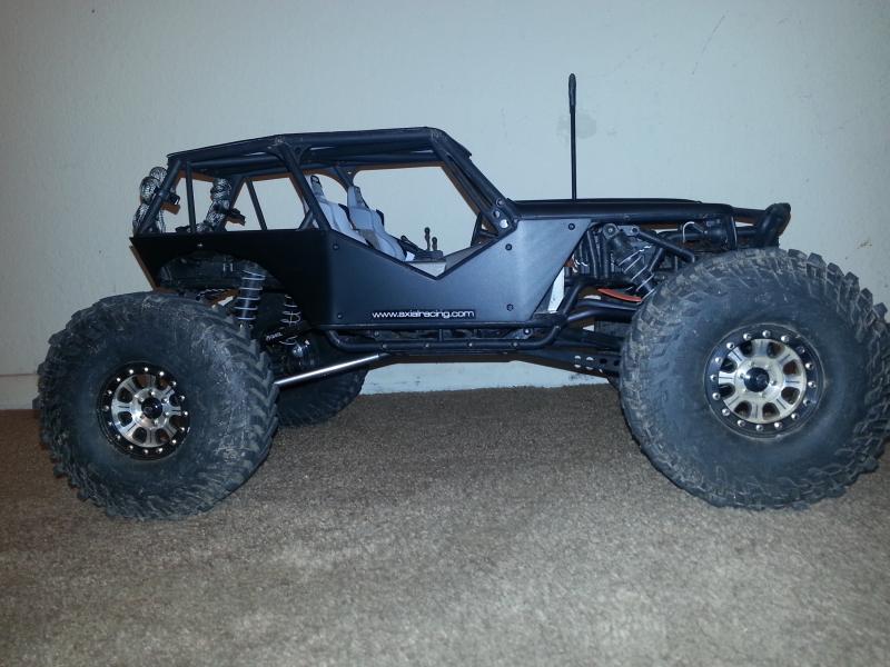 Mickey Thompson tires, RC4WD Hitman beadlocks, axial aluminum suspension links, flat black painted body