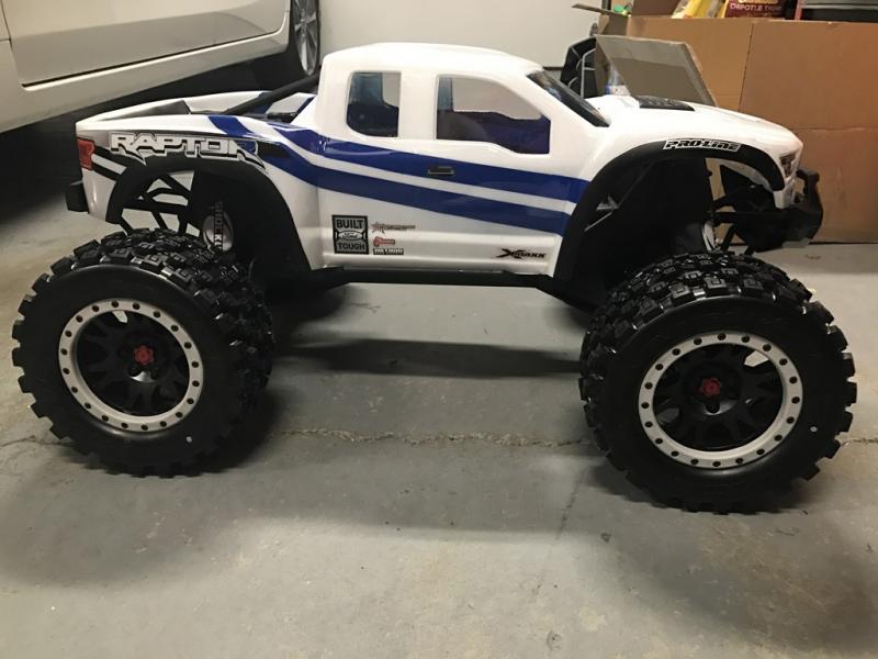 X-Maxx Pro-line Raptor body with Pro-line Badlands Tires MX43 with Impulse Pro-Loc Wheels